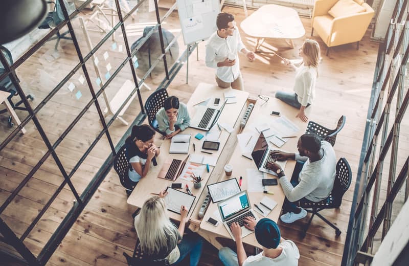 Overhead office meeting representing career path exploration